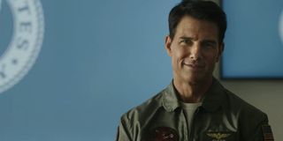 Top Gun: Maverick Tom Cruise smiling in a briefing room