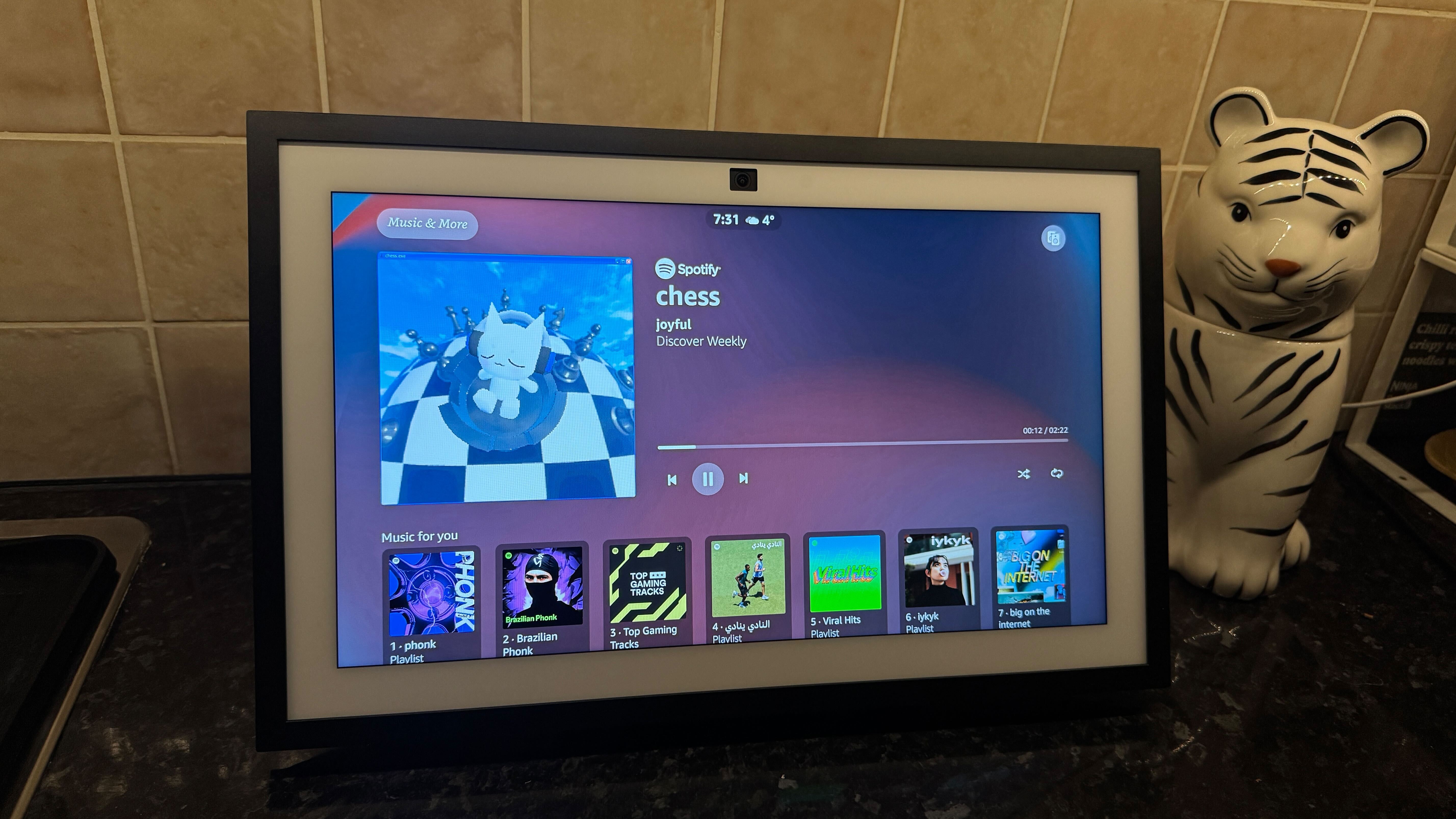 Amazon Echo Show on a counter displaying the Spotify app.