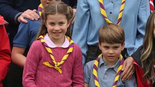 Princess Charlotte and Prince Louis pose for a group pictures with volunteers who are taking part in the Big Help Out in 2023