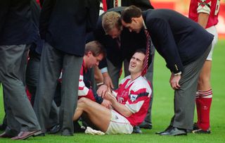 Arsenal manager George Graham checks on Steve Morrow after he was dropped by Tony Adams following the Gunners' win over Sheffield Wednesday in the 1993 League Cup final.