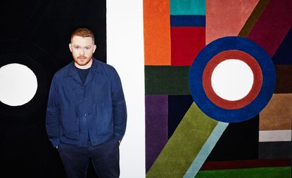 Fashion designer Craig Green with his black and multicoloured ceremonial rugs