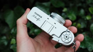 Fujifilm X Half camera held in a hand