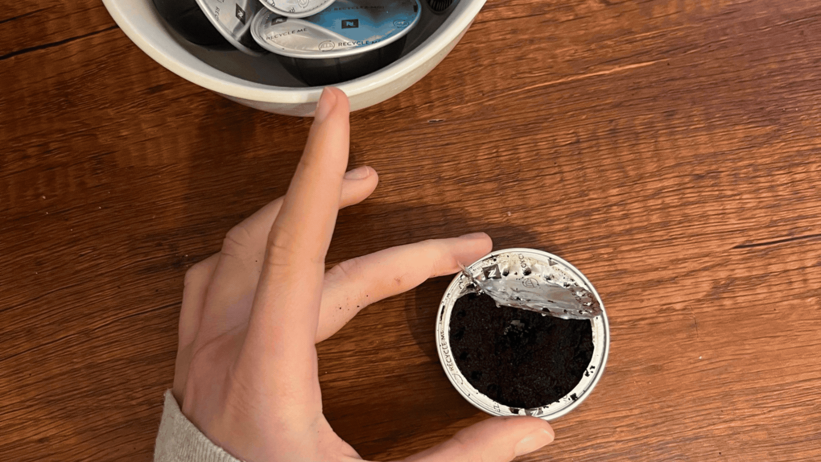 Rotating GIF of three images showing a hand refilling coffee pod capsules.
