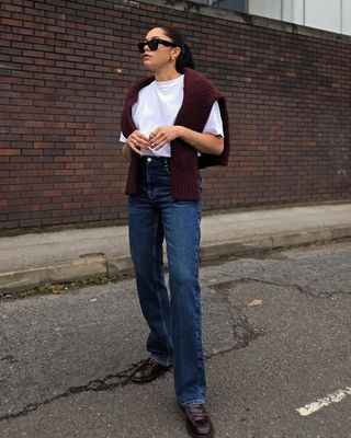 woman wearing sweater, jeans, and loafers spring outfit