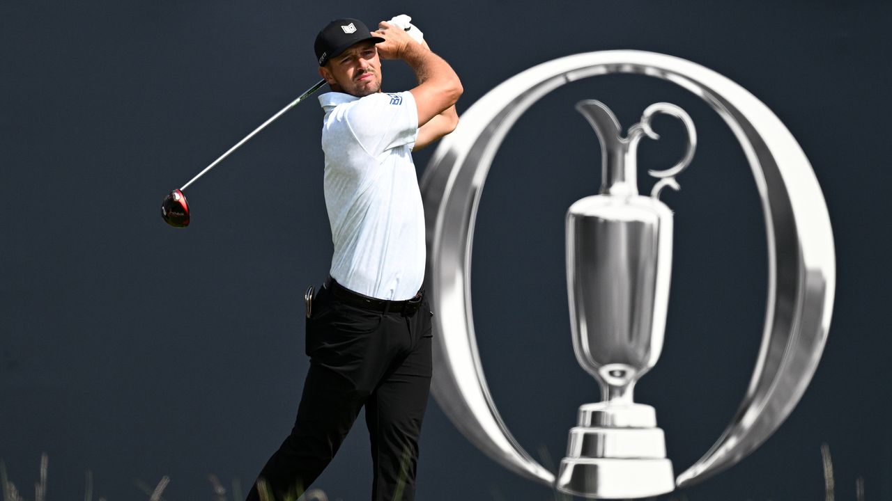 Bryson DeChambeau hits a tee shot at The Open with a Claret Jug logo behind