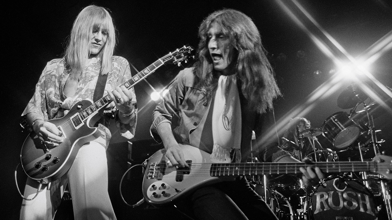 Alex Lifeson and Geddy Lee from Rush perform live on stage in Springfield, Massachusetts 9th December 1976. (Photo by Fin Costello/Redferns)