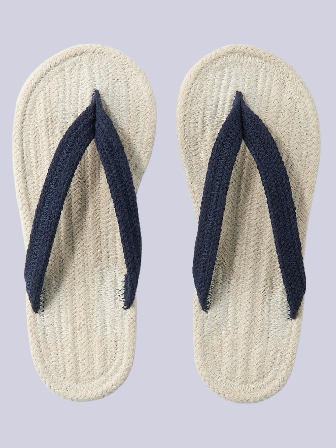 A pair of open woven indoor slippers from Muji with an ecru base and navy straps