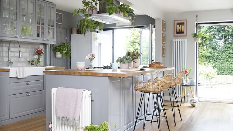 Grey Shaker-style kitchen and island with rattan bar stools