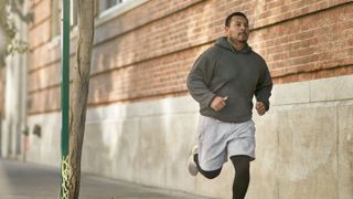 Man doing zone 2 training by jogging on street