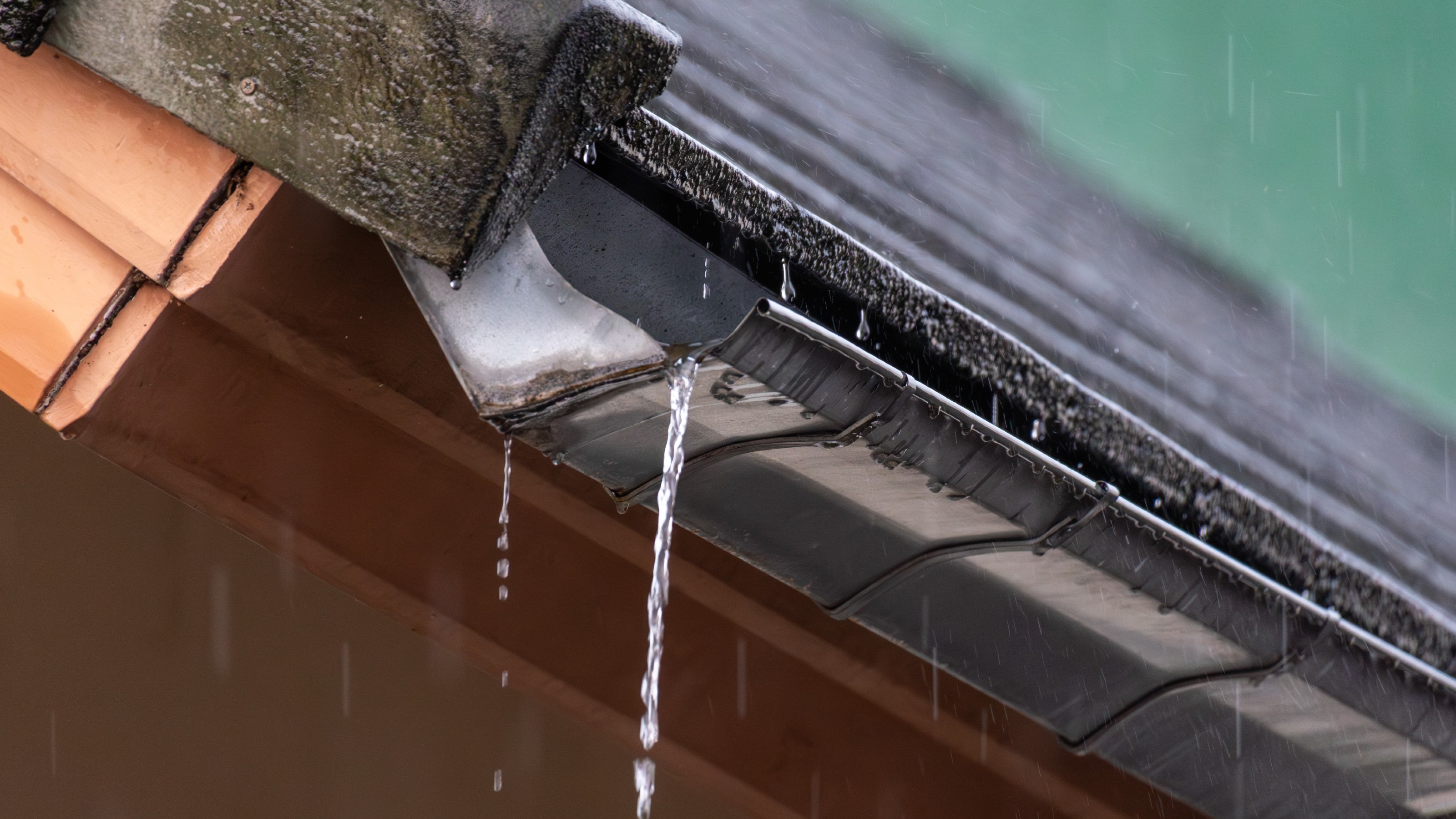 Water leaking from house guttering during heavy rain