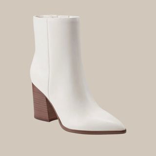 flat lay image of white heeled boots