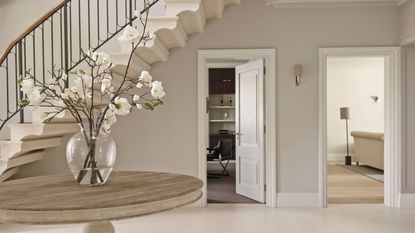 Hallway, grand entrance, round table, vase of flowers, tiled floor