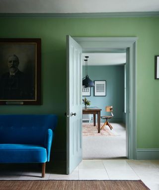 green hallway with blue couch