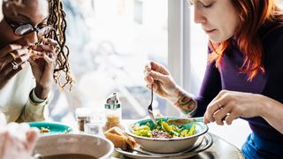 two women enjoying a vegan meal