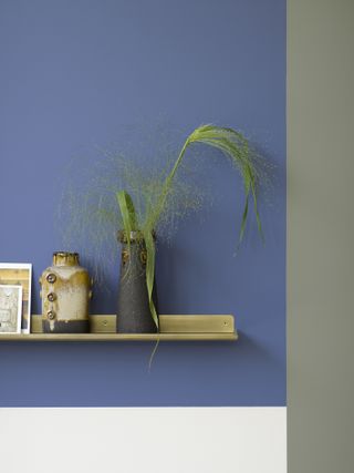 floating shelf on blue painted wall