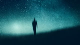 An atmospheric, moody concept of a figure walking towards the camera silhouetted against the night sky. With an abstract, artistic edit.