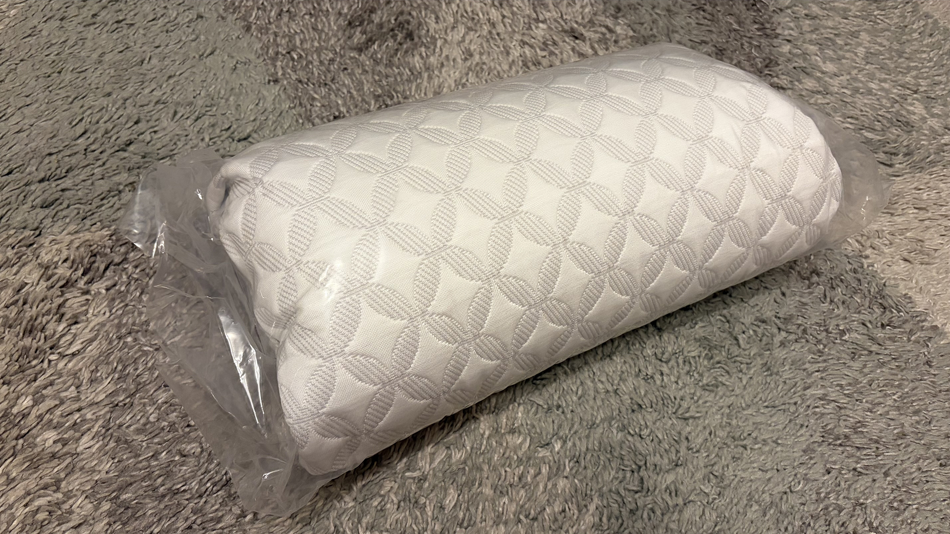 The Helix Talalay Latex pillow rolled up in plastic packaging