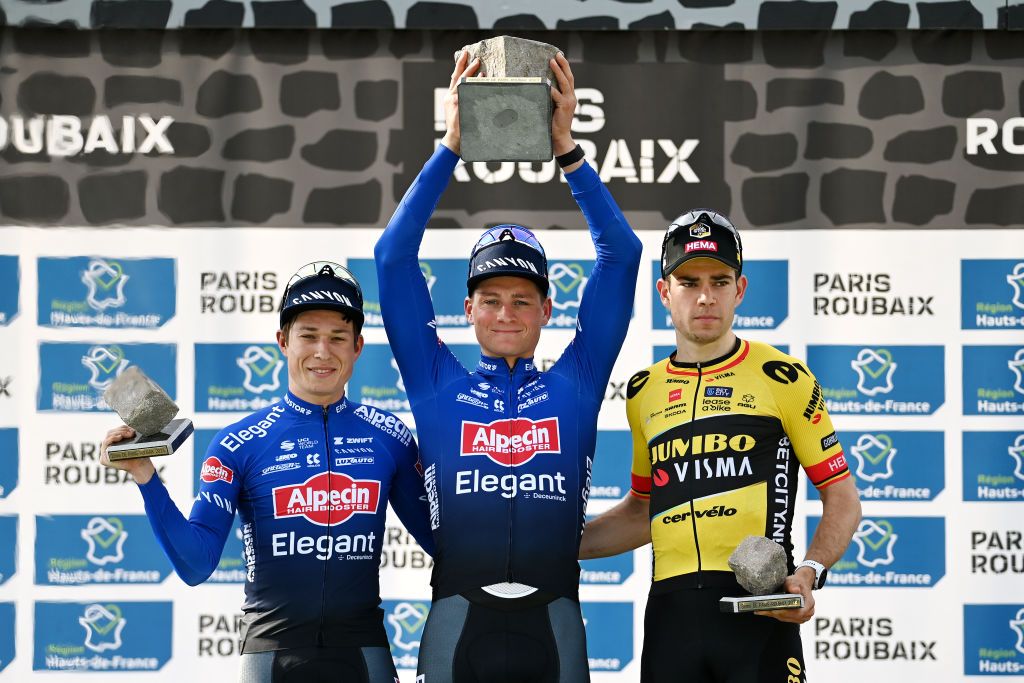 Paris-Roubaix winner Mathieu van der Poel hoists the cobblestone trophy 