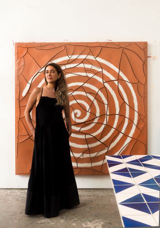 Adriana Varejão stands in front of her new painting