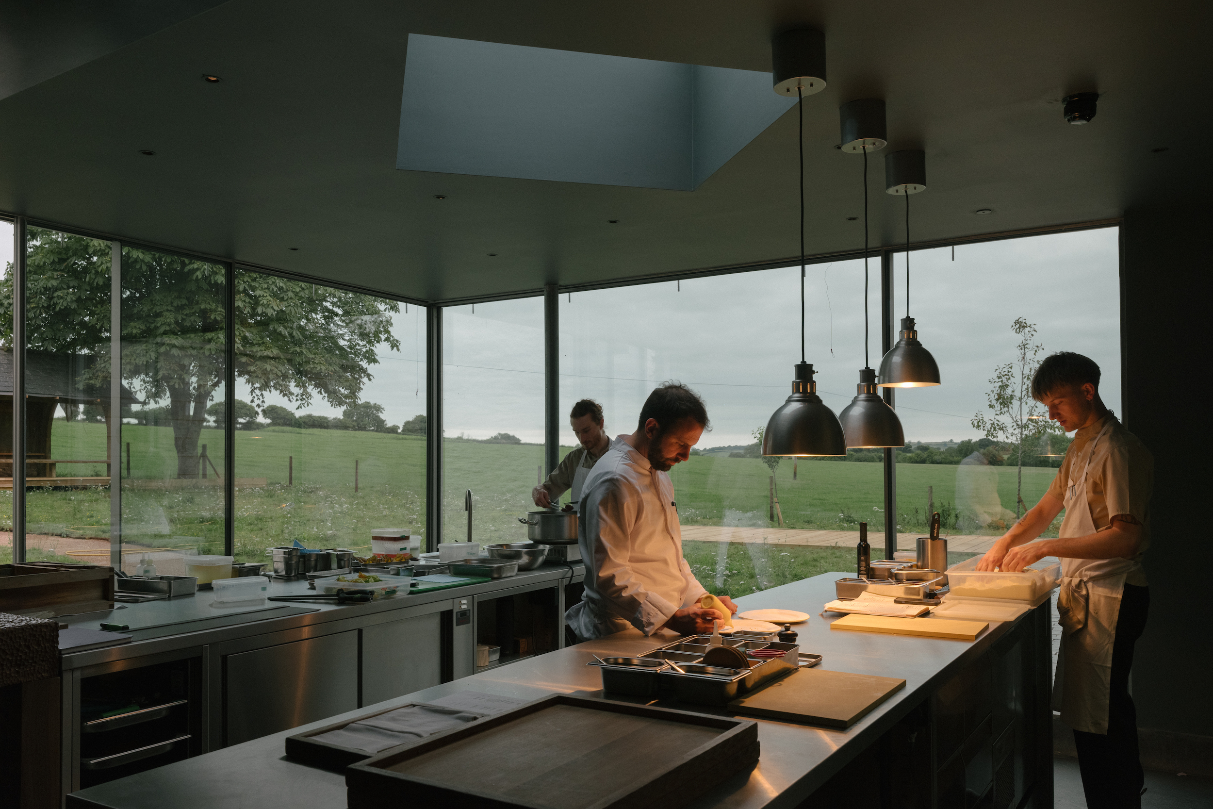 A team of chefs plate up food in the open-plan kitchen at Osip in Somerset.