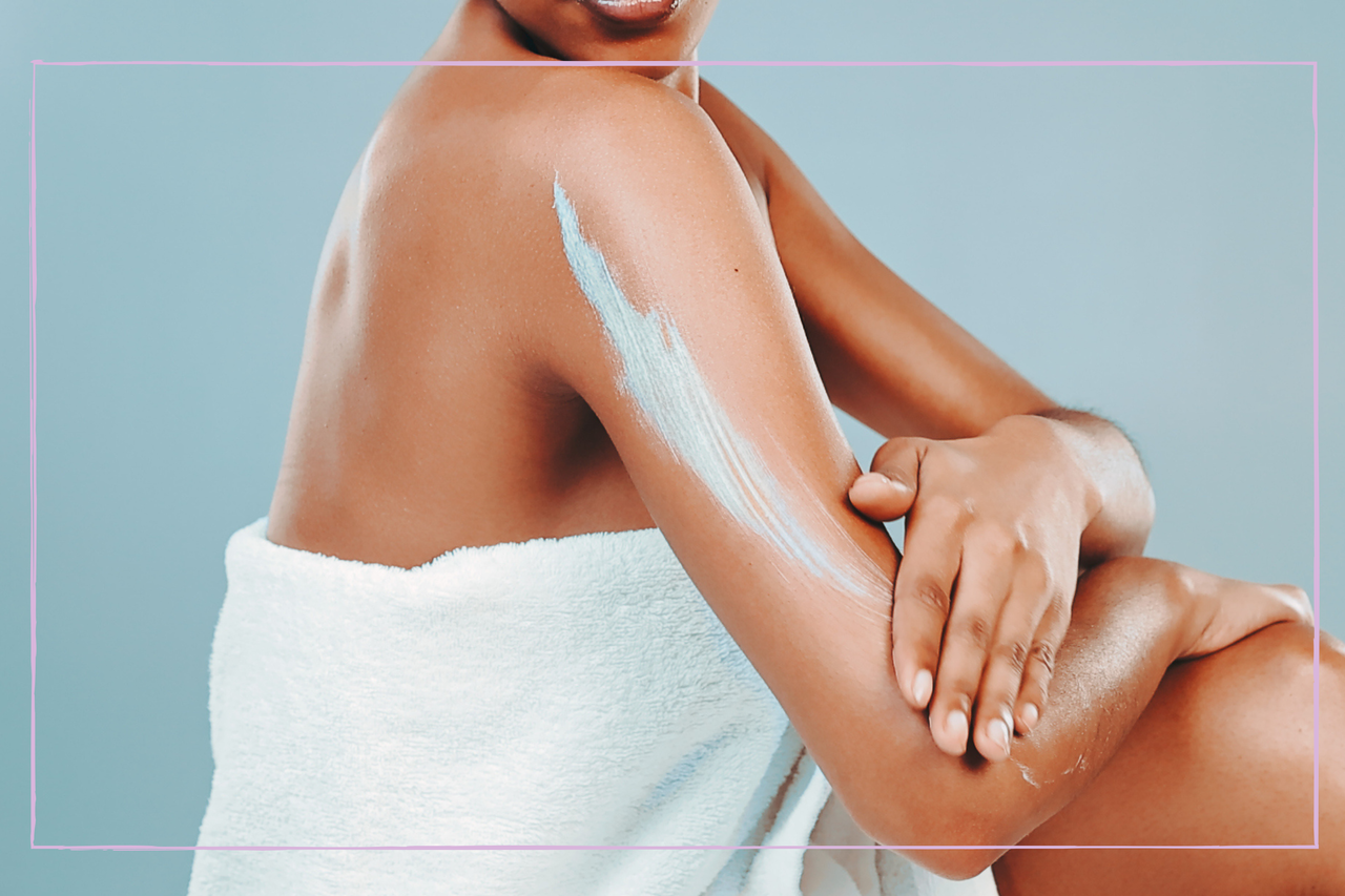 Woman applying cream to remove fake tan