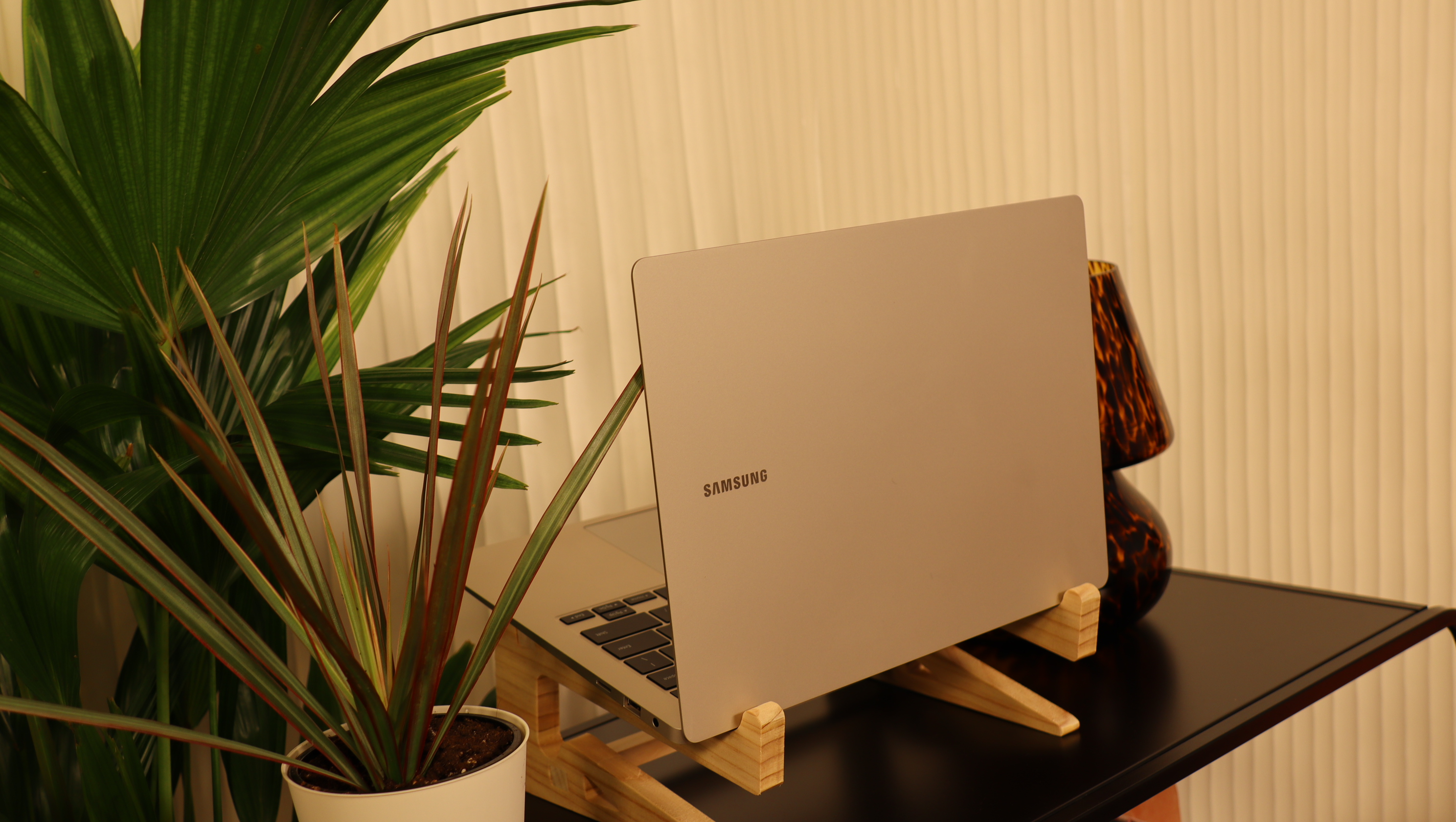 Samsung Galaxy Book3 on a wooden stand