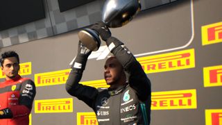 Lewis Hamilton holds his trophy aloft in F1 Manager 2022