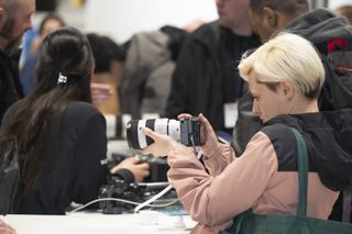 A person trying out a camera at The Photography and Video Show 2024