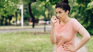 Portrait of a girl using asthma inhaler during jogging