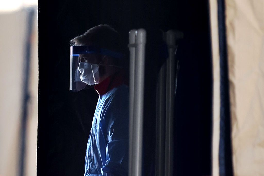 Healthcare professionals prepare to screen people for the coronavirus at a testing site erected by the Maryland National Guard in a parking lot at FedEx Field March 30, 2020 in Landover, Mary