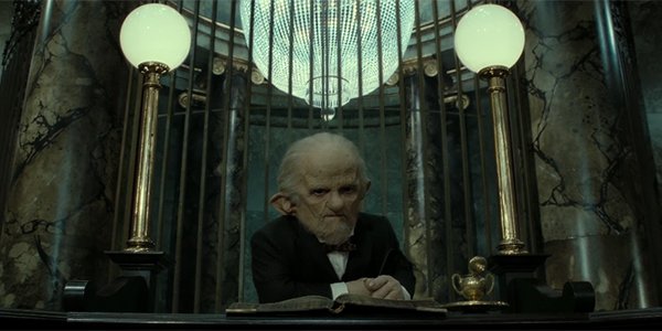 A goblin sitting at Gringotts Wizarding Bank