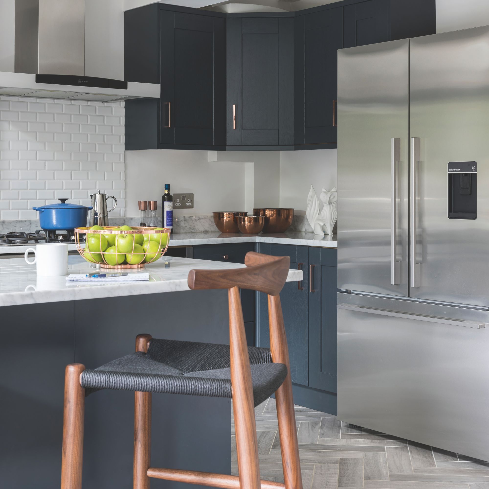 Kitchen with blue cabinets and a large american-style fridge-freezer
