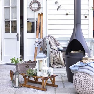 patio area with fire place and white door
