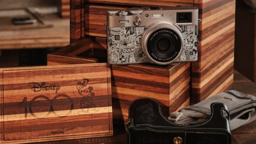 Disney-themed Fujifilm X100V camera and all its accessories on a wooden table