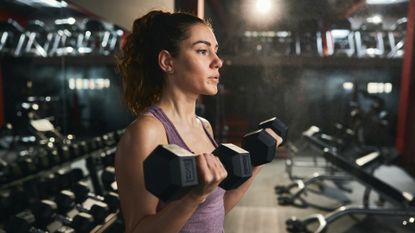 Woman performing bicep curls with dumbbells