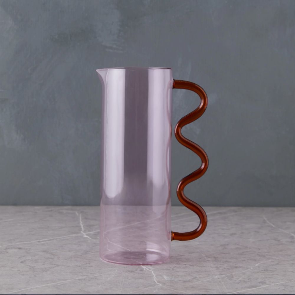 Pink glass pitcher with red wavy handle