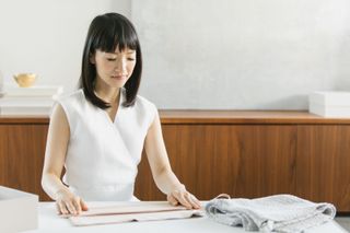 Marie Kondo pictured organizing and folding towels
