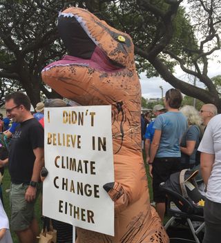 Michelle Holewa donned a T. rex costume for today's March for Science in Honolulu.