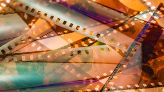 DYBKCH closeup of 35mm color film negative strips, laid on top of each other on a lightbox