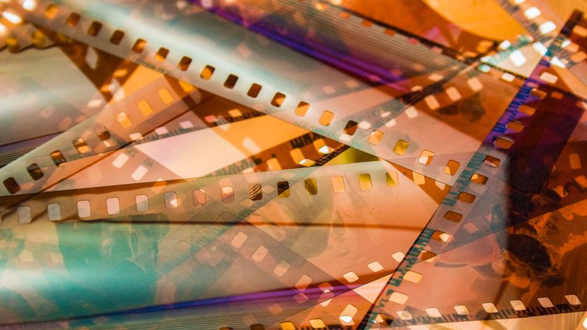 DYBKCH closeup of 35mm color film negative strips, laid on top of each other on a lightbox