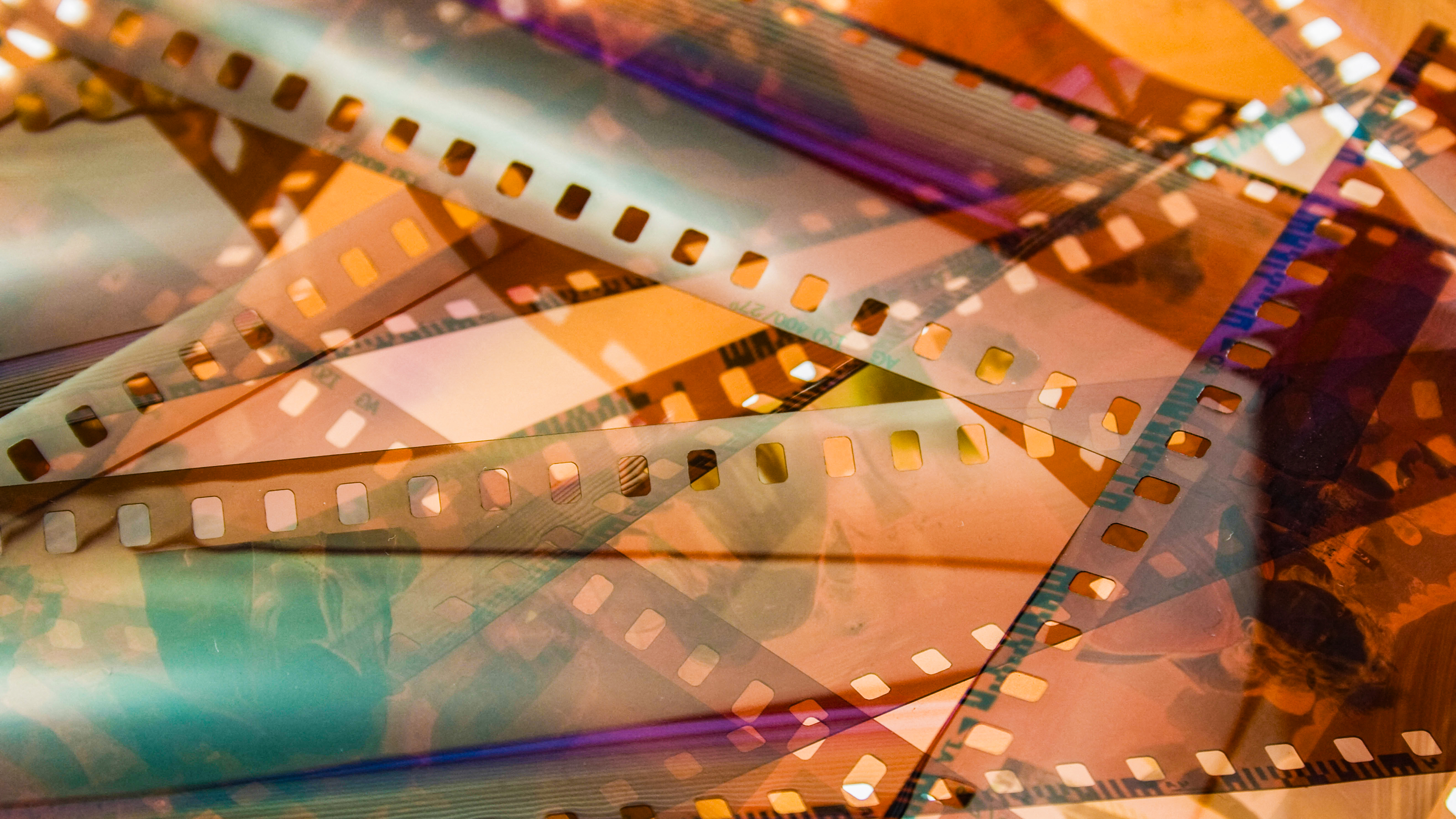 DYBKCH closeup of 35mm color film negative strips, laid on top of each other on a lightbox