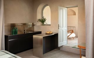 An old Italian locanda has been reinvented through chrome modern furnishings characterized by sculptural looks, which perfectly complement the space's plaster walls.