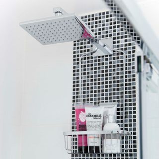 bathroom with shower head and mosaic tiles