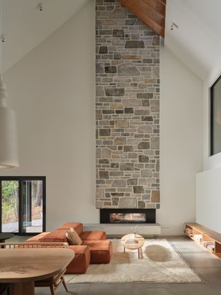 The main double-height living space with its stone-clad fireplace