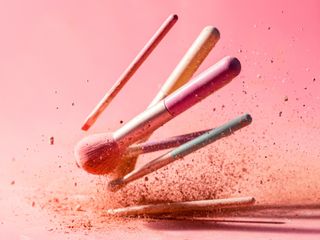 make-up brushes on pink background