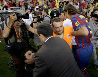 Zlatan Ibrahimovic is shielded by security guards at Camp Nou as fans invade the pitch during the Swedish striker's presentation in July 2009.