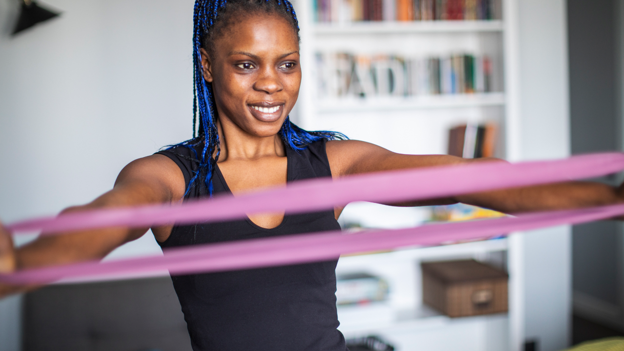 Woman doing full-body resistance band workout