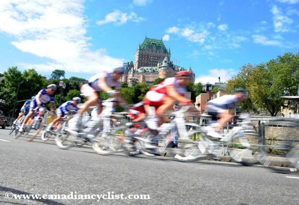 Racers are a blur along the river front