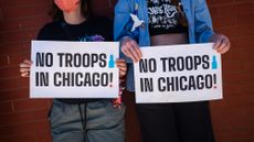 CHICAGO, ILLINOIS - SEPTEMBER 1: People hold "No Troops in Chicago" signs during the Labor Day Workers Over Billionaires rally, in solidarity with labor unions and advocacy groups, on September 1, 2025 in Chicago, Illinois. The demonstration was one of hundreds scheduled to take place across the country today, in opposition to the Trump administration's policies.