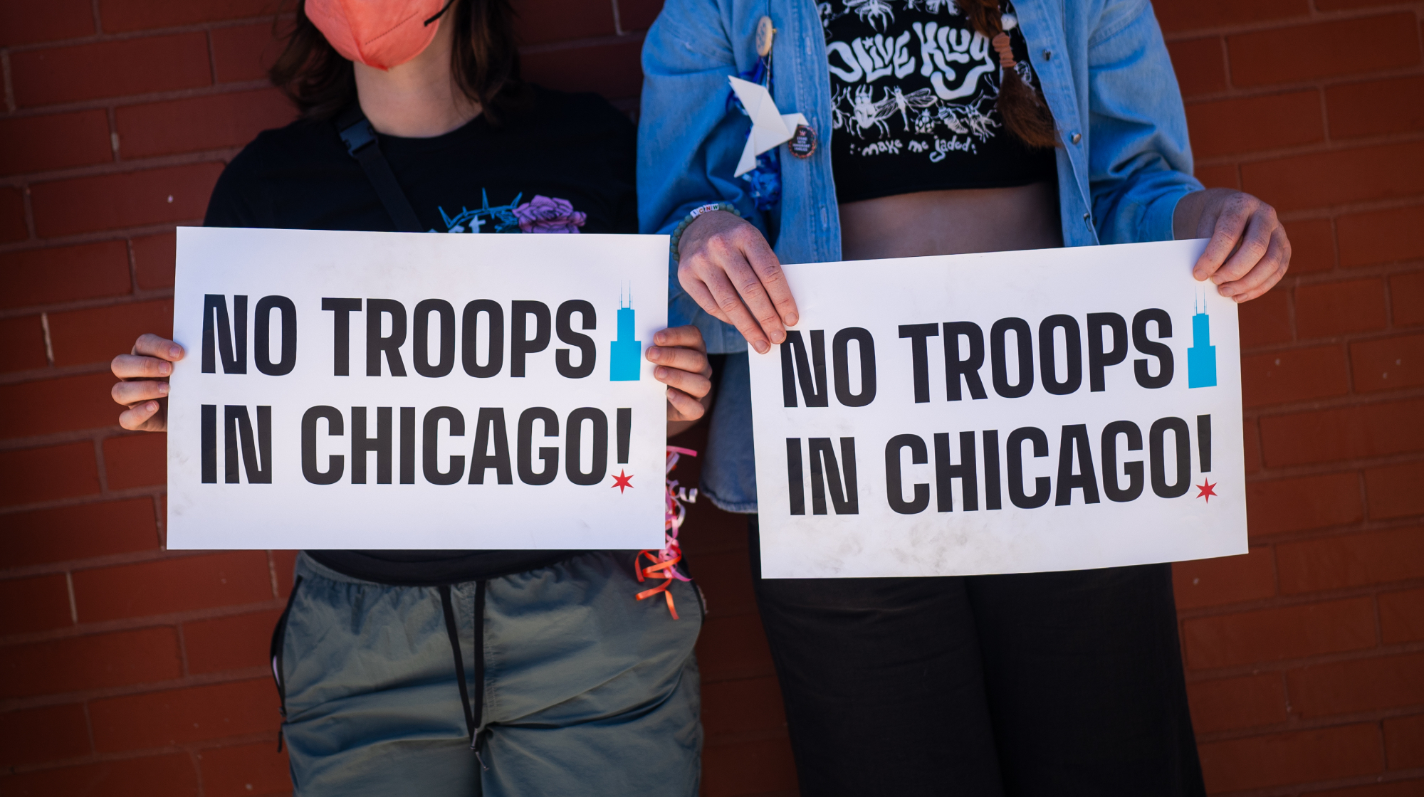 CHICAGO, ILLINOIS - SEPTEMBER 1: People hold "No Troops in Chicago" signs during the Labor Day Workers Over Billionaires rally, in solidarity with labor unions and advocacy groups, on September 1, 2025 in Chicago, Illinois. The demonstration was one of hundreds scheduled to take place across the country today, in opposition to the Trump administration's policies. 